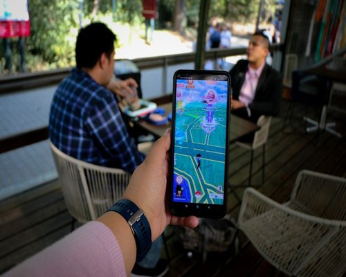 Smartphone displaying a fictional mobile game at an Australian gaming technology exhibition