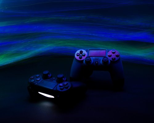 Modern gaming console setup illuminated in purple light